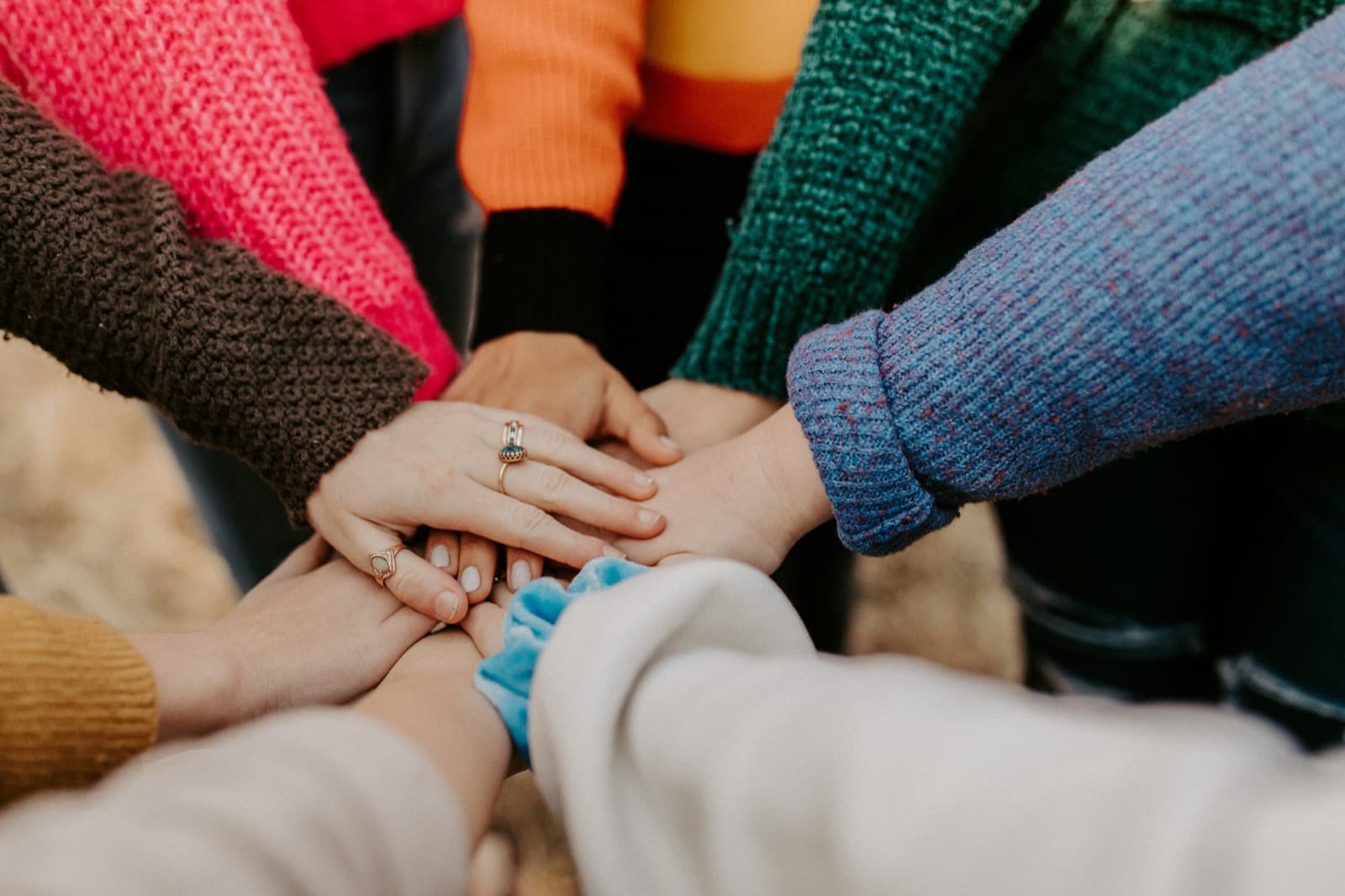 A group of people placing their hands together